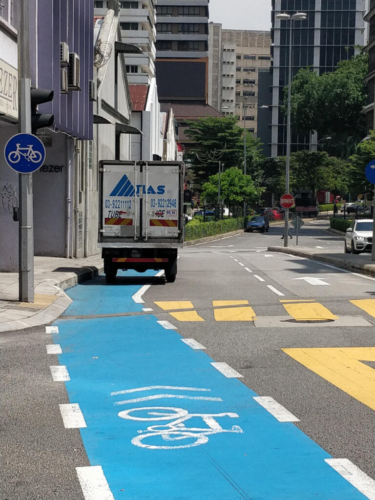 A bike lane is used for parking. Kuala Lumpur, summer 2019.